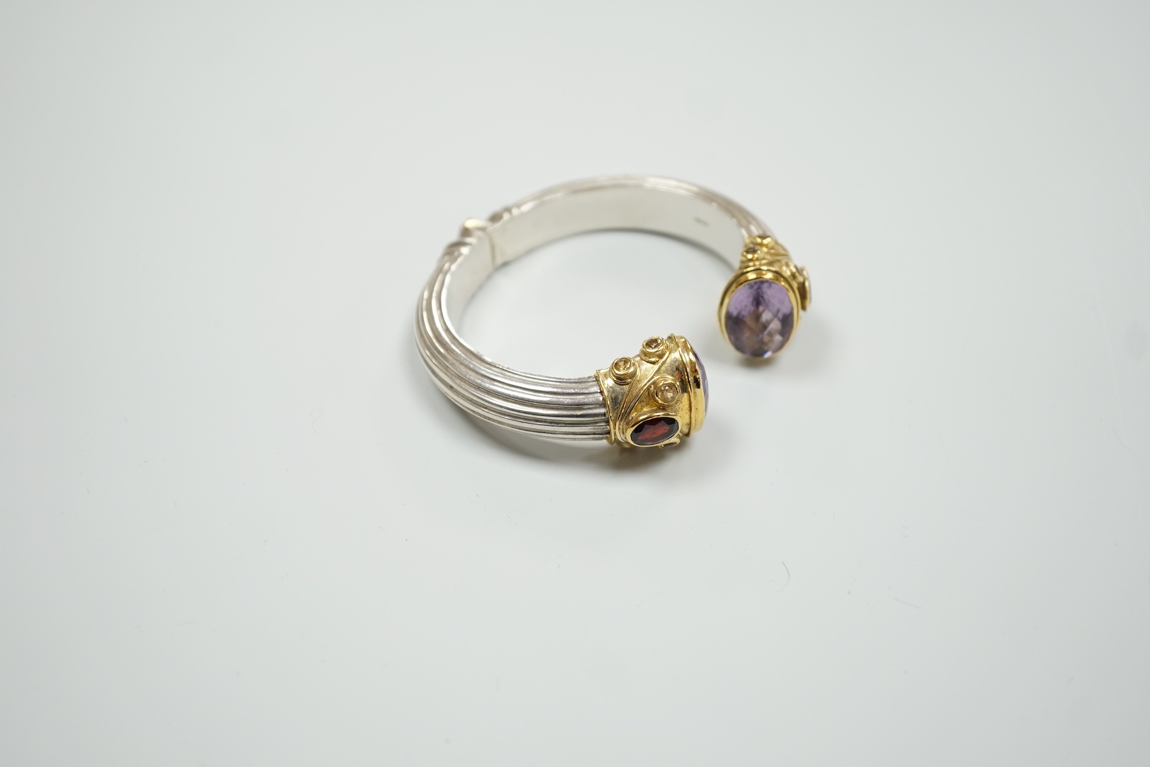 A modern parcel gilt silver amethyst and citrine set openwork spring hinged bangle.